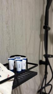 three blue and white cups sitting on a black tray at Grandstay in Al Hofuf +3 photos