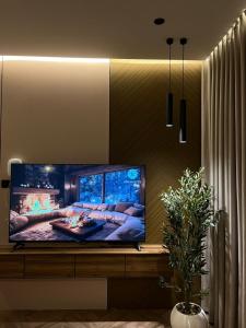 a flat screen tv sitting on a table in a living room at Grandstay in Al Hofuf