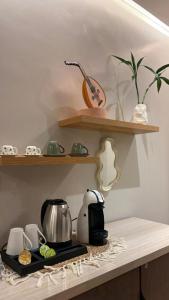 a kitchen counter with a coffee maker on a stove at Grandstay in Al Hofuf