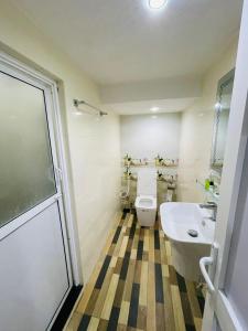 a bathroom with a toilet and a sink at Palmyra resort in Jaffna +17 photos