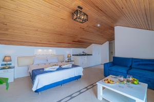 a bedroom with a bed and a blue couch at Azure Palm Resort in Oludeniz