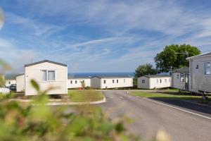 a row of houses on the side of a road at Tencreek Holiday Park in Looe