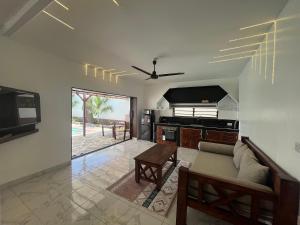 a living room with a couch and a kitchen with a table at Casa Yangu in Watamu