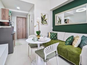 a living room with a couch and a table at Kajas Condo Luxe at Primeworld District near Mactan-Cebu International Airport in Lapu Lapu City