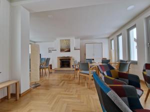 a living room with chairs and a table and a fireplace at Gästehaus Dominikus in Leipzig