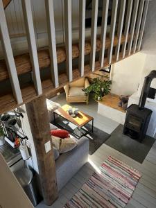 a living room with a couch and a wood stove at Cosy Cottage Vollheim in Lillehammer