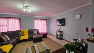 a living room with a couch and a tv at Lindas Haven in Swakopmund