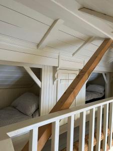a bunk bed with a staircase in a room at Cosy Cottage Vollheim in Lillehammer