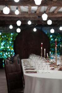 a long table with wine glasses and candles on it at Hôtel L'Ouvrée in Savigny-lès-Beaune