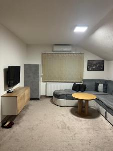 a living room with a bed and a table at Apartments Aventra in Visoko +81 photos
