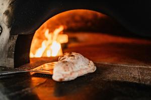 a piece of food is coming out of an oven at Hótel Valaskjálf in Egilsstaðir