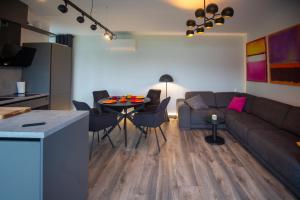 a living room with a couch and a table at Laumiņas in Pavasari