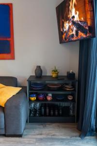 a living room with a fireplace and a couch at Laumiņas in Pavasari