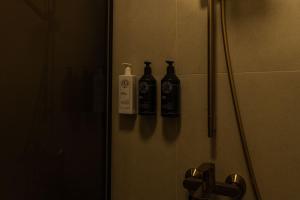 a bathroom with three bottles on a shower door at Laumiņas in Pavasari +57 photos