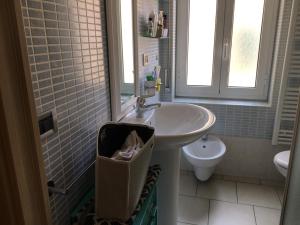 a bathroom with a sink and a toilet at BnB Cairoli - Homezon in Diano Marina +13 photos