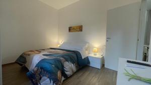 a small bedroom with a bed and a table at La Contessa Home in Avellino