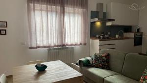 a living room with a couch and a table at La Contessa Home in Avellino +4 photos