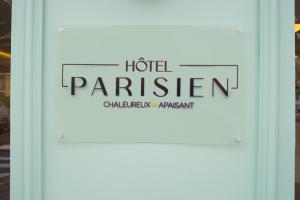 a sign on a door that reads hotel parliament at Hotel Parisien in Menton