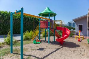 a playground with a slide in a yard at Palmora Lara Hotel in Aksu