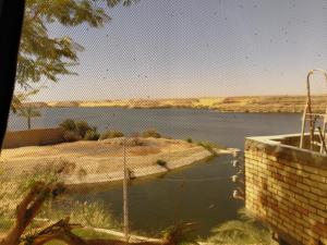 a fence with a view of a body of water at Amon guest house in Abu Simbel