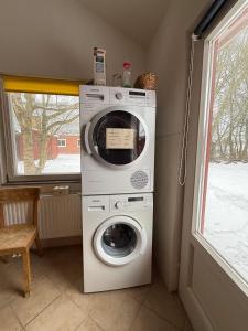 a washer and dryer in a room with a window at Lachmöwe in Munkbrarup