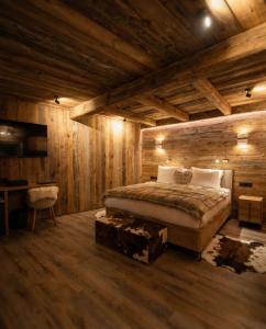 a bedroom with wooden walls and a bed in a room at Hotel Vall d'Isard Suites in El Tarter +31 photos