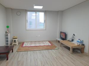 a large white room with a table and a window at Stay Mokpo,2R1B,목포역,케이블카,동부시장,최대4인 in Mokpo +8 photos
