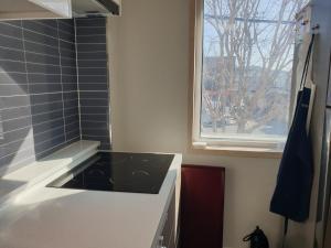 a kitchen with a stove and a window at Stay Mokpo,2R1B,목포역,케이블카,동부시장,최대4인 in Mokpo