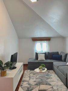 a living room with a couch and a table at Maria apartment in Ponta do Sol