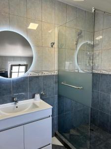 a bathroom with a sink and a shower at Maria apartment in Ponta do Sol +26 photos