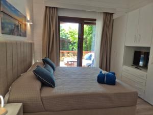 a bedroom with a bed with blue pillows on it at Residence Villalsole in San Felice del Benaco