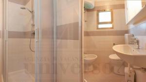 a bathroom with a shower and a toilet and a sink at Bungalow Baleno in Eraclea Mare