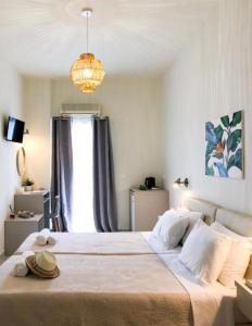 a bedroom with a large bed with a chandelier at stelisia2 in Chania