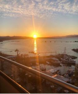 a sunset over a marina with boats in the water at stelisia2 in Chania