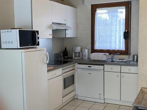 a kitchen with white cabinets and a white refrigerator at KREISKER 4 - Maison Jumelée, Jardin - CA6010 in Carnac
