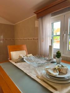 a table with a glass plate on top of it at Maria apartment in Ponta do Sol