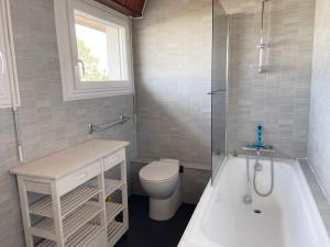 a bathroom with a toilet and a tub and a sink at VOILE D'ETAI - Maison, Calme, Jardin Clos - K343 in Carnac +10 photos