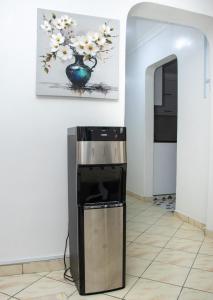 a refrigerator in a room with a painting on the wall at Cozy urban homes in Nakuru