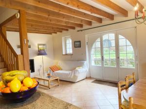 a living room with a couch and a table at KERDERFF - Longere entre plage et foret - TK30 in Carnac