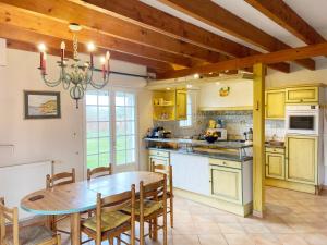 a kitchen with a wooden table and a dining room at KERDERFF - Longere entre plage et foret - TK30 in Carnac