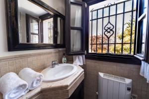 a bathroom with a sink and two windows at GAV Ciudad in Ronda +33 photos