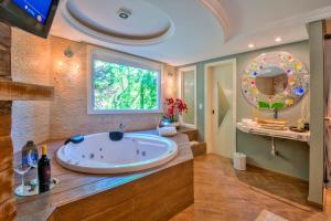 a large bathroom with a large tub and a window at La vanguardia by Don Ramon Hotel Boutique & Spa in Canela +52 photos