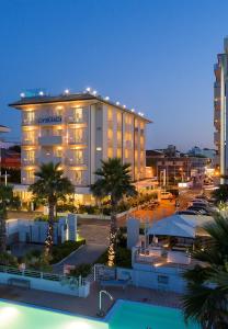 a hotel with a pool in front of a building at Hotel Ca' Bianca in Riccione
