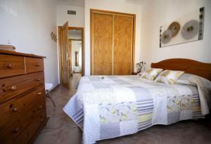a bedroom with a bed and a wooden dresser at Bluemoon 2 in Mazarrón