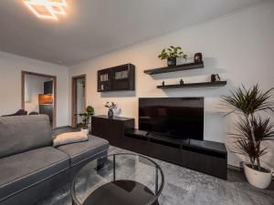 a living room with a couch and a fireplace at Talblick - Apartment Hortensie in Losheim