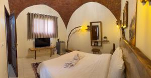 a bedroom with a bed with white towels on it at King Sahure Pyramid Inn in Cairo