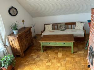 a living room with a bed and a coffee table at Sziget Gyöngye Vendégház in Tahitótfalu