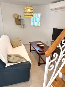 a living room with a couch and a table at Torre a Sant Martí d'Empúries in L'Escala