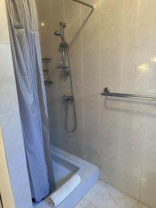 a bathroom with a shower with a shower curtain at Torre a Sant Martí d'Empúries in L'Escala +18 photos