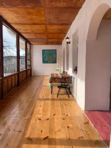 a large room with wooden floors and a wooden ceiling at Guesthouse Lantia in Mestia